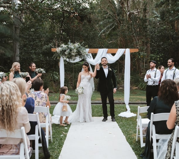 Bride and groom holding hands at their wedding