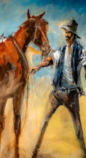 Close-up painting of a cowboy in a wide hat holding a brown horse's reins, rendered with loose brushstrokes and warm tones