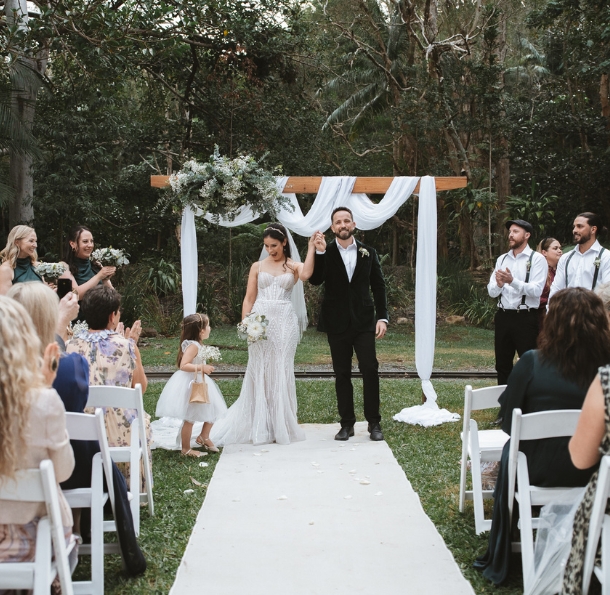 Bride and groom holding hands at their wedding