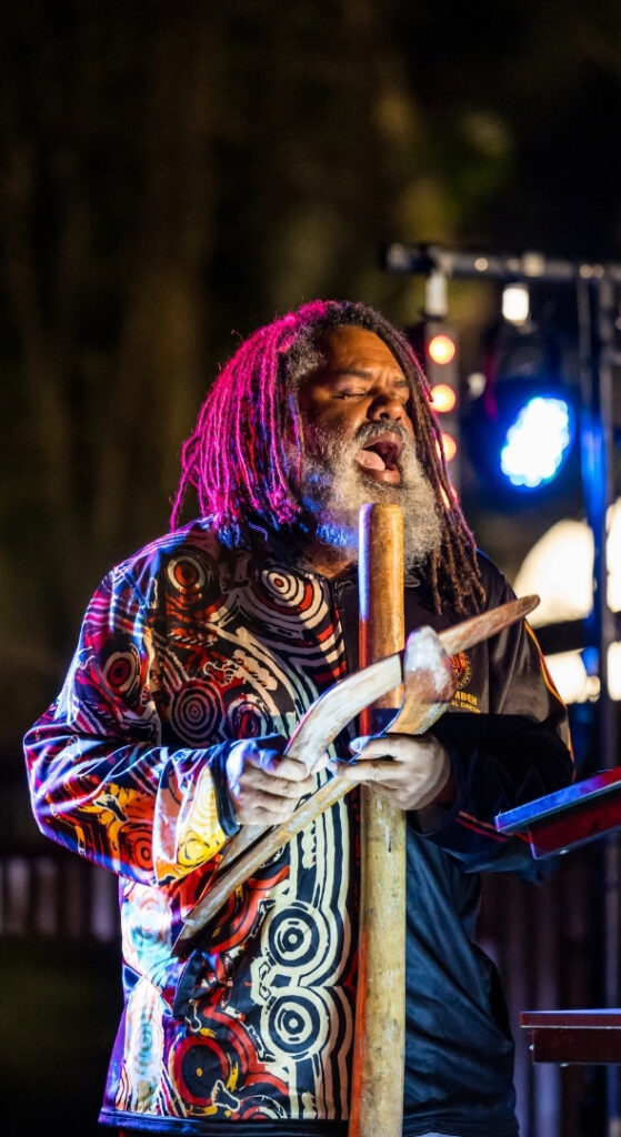 Aboriginal performer showcasing traditional culture at an evening event