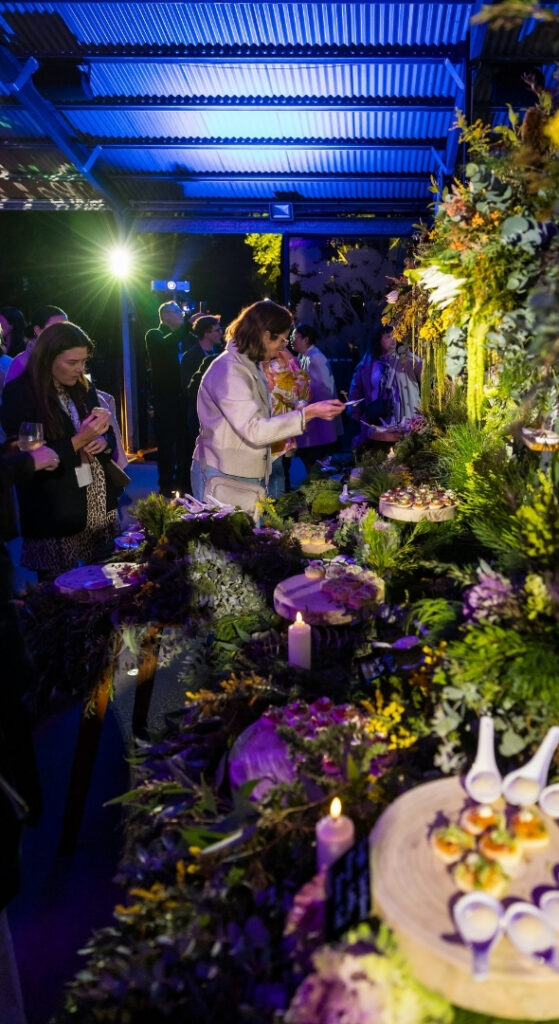 Guests browsing a nature-inspired grazing buffet at an evening event, Currumbin Wildlife Sanctuary