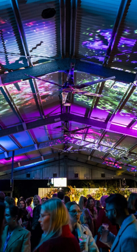 Guests gathered under a covered outdoor pavilion at a night event, Currumbin Wildlife Sanctuary